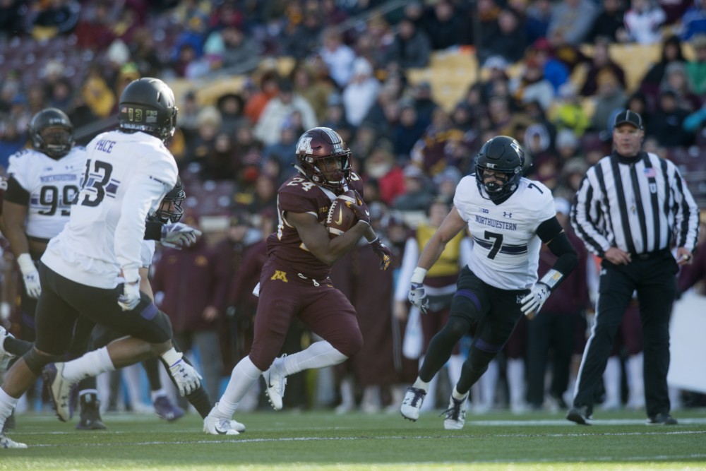 Running back Mohamed Ibrahim carries the ball on Saturday, Nov. 17 at TCF Bank Stadium.