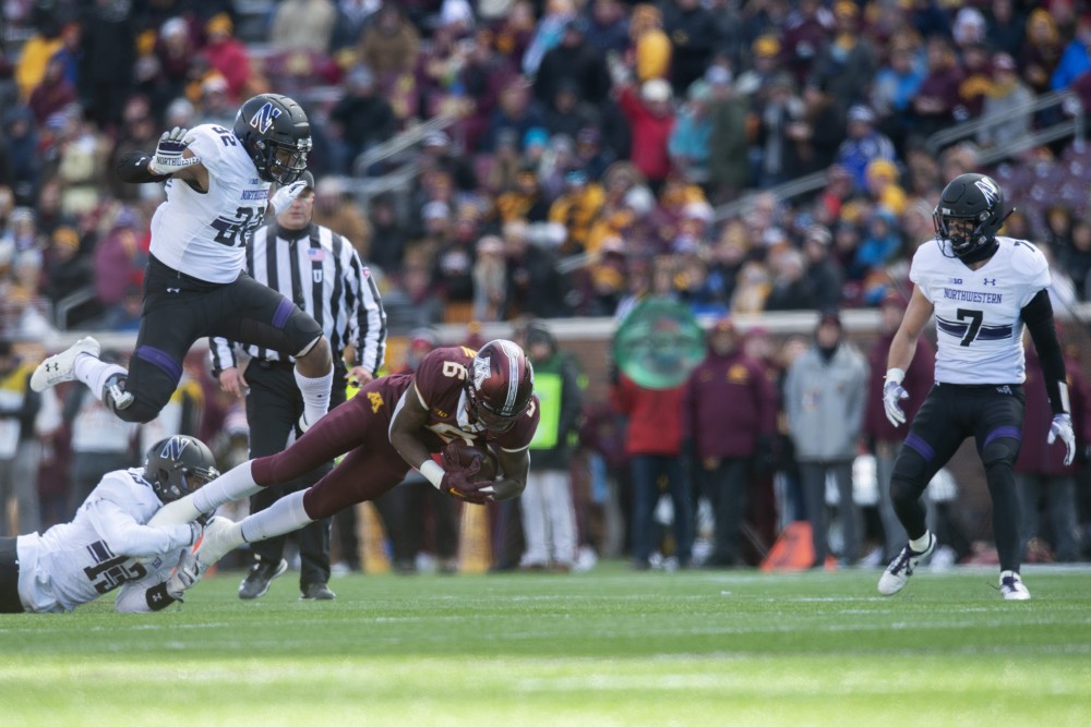Wide receiver Tyler Johnson dives from a tackle during the game against Northwestern on Saturday, Nov. 17 at TCF Bank Stadium.