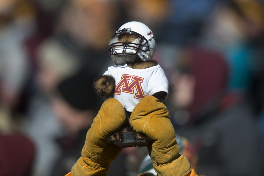 A miniature Gopher mascot is held in the air during the last home game of the season on Saturday, Nov. 17 at TCF Bank Stadium. 