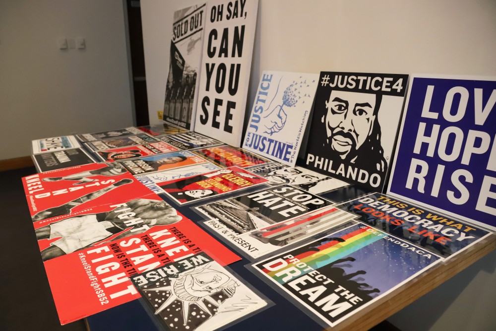 Posters are displayed to inspire students in their poster making during an art activist poster making event on Friday, Nov. 16 at the Weisman Art Museum in Minneapolis.