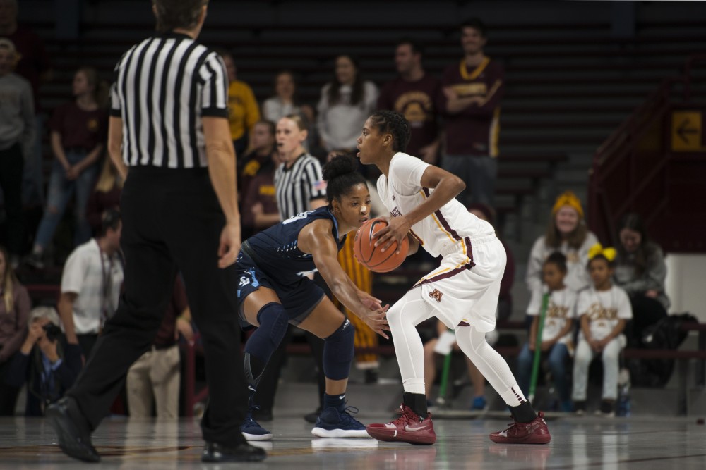 Redshirt Senior Guard Kenisha Bell looks to pass the ball during the game against San Diego on Saturday, Nov. 17 at Williams Arena.