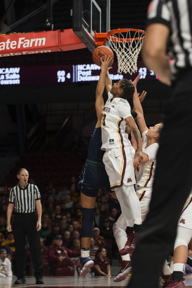 Redshirt Senior Guard Kenisha Bell jumps for the ball during the game against San Diego on Saturday, Nov. 17 at Williams Arena.