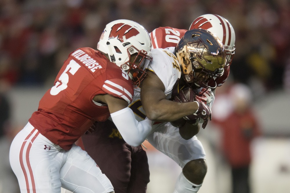 Runningback Mohamed Ibrahim breaks two tacklers at Camp Randall Stadium in Madison on Saturday, Nov. 24. The Gophers beat the Badgers 37-15 for the first time since 2003.