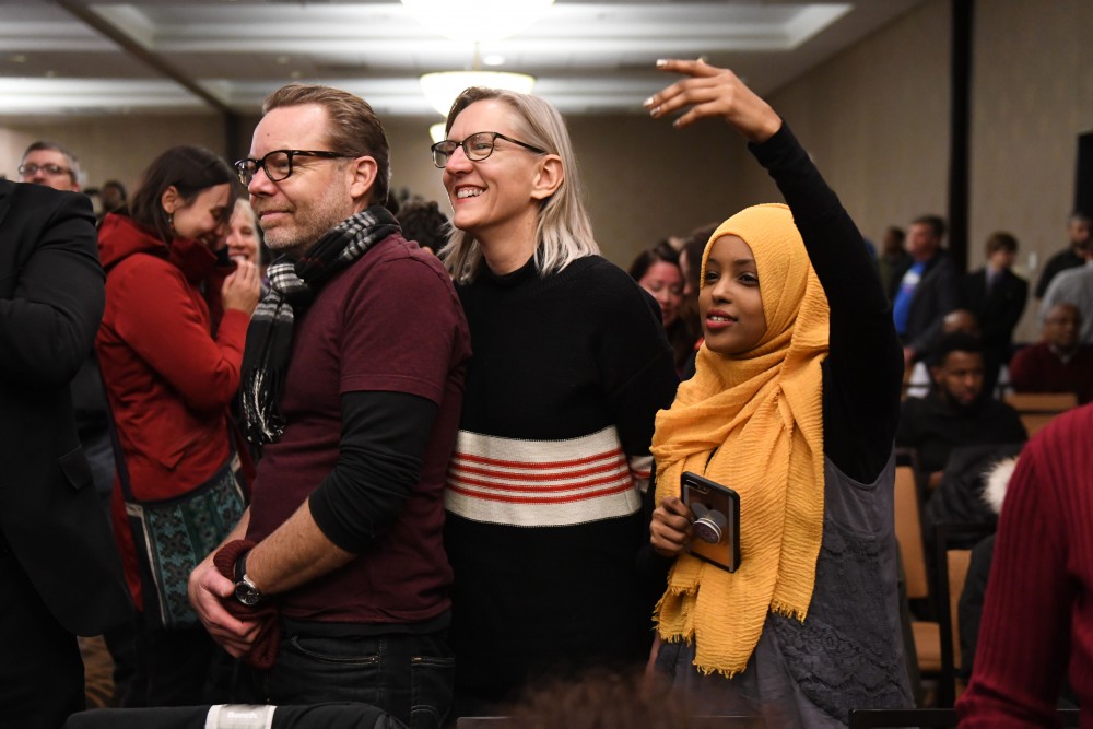 Eric Freeburg, Beth Toso and Ramlo Mohamed celebrate at Ilhan Omars election party in downtown Minneapolis on Tuesday, Nov. 6.