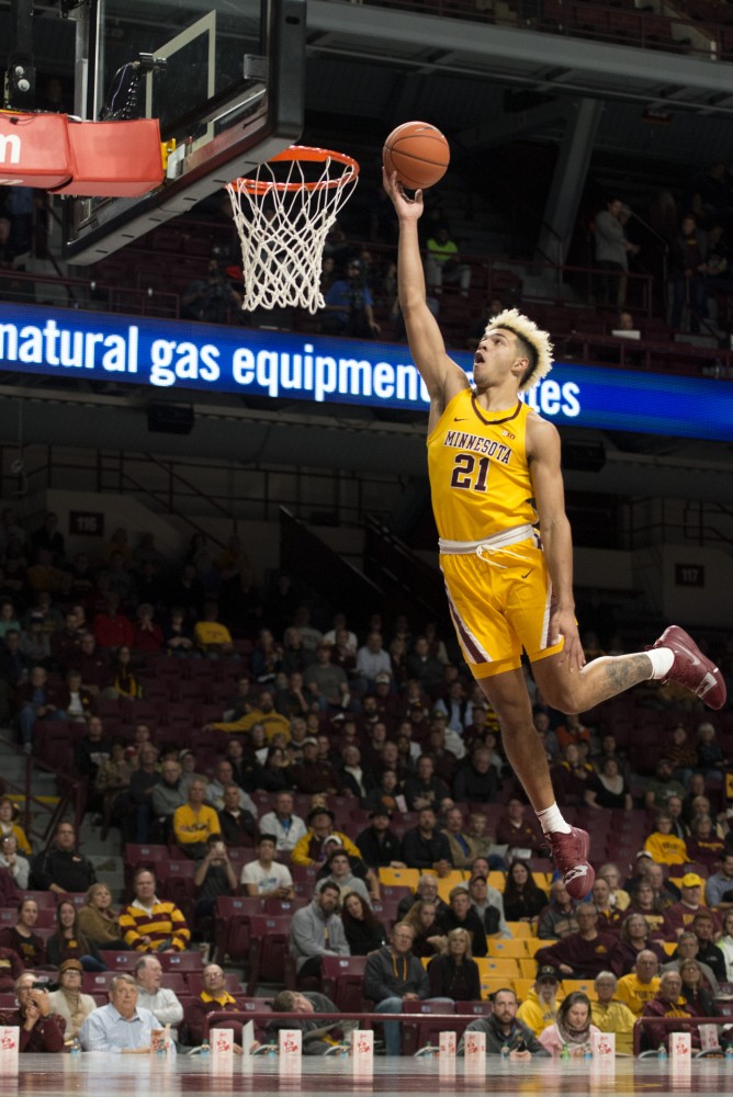 Forward Jarvis Omersa jumps to dunk the ball at Williams Arena on Thursday, Nov. 1. The Gophers defeated the Bulldogs 109-53. 