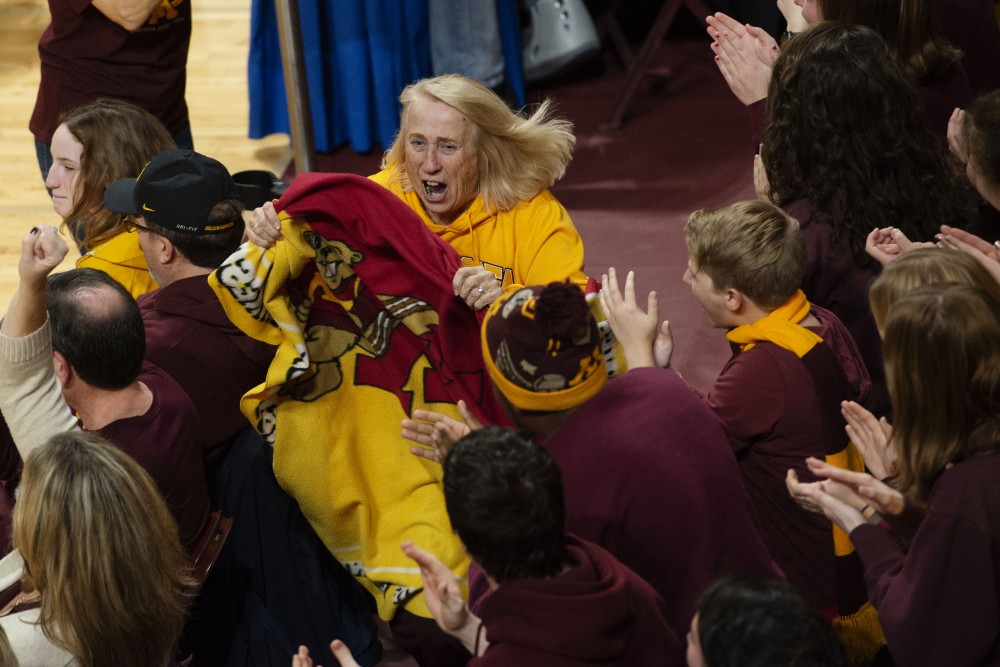Fans cheer for the blanket lady as she runs through the Maturi Pavilion on Friday, Nov. 30. The Gophers swept Bryant three sets to none as a start to their postseason.
