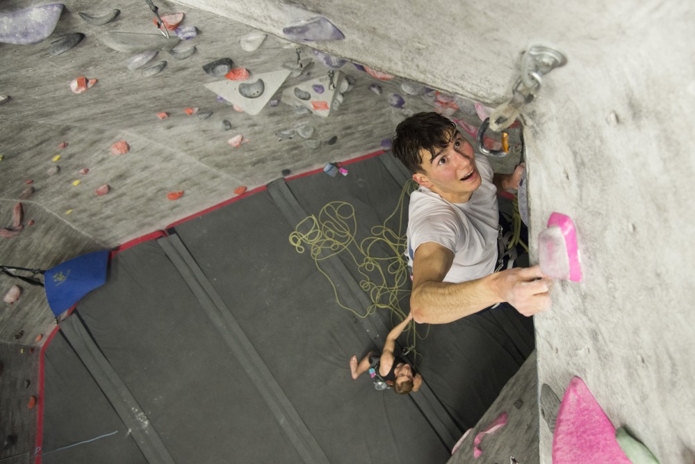 Michael Laraia eyes his next hold as part of a lead climb during practice with the Universitys climb team on Tuesday, Nov. 13. 