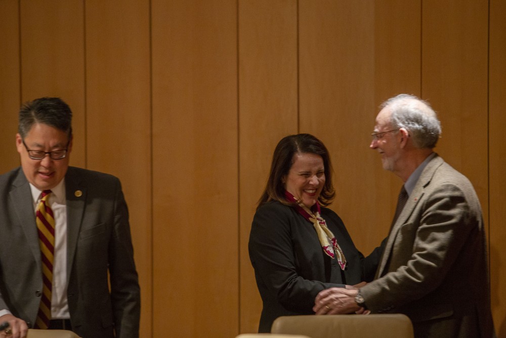 University President-designate Joan Gabel shakes the hand of Regent Ken Powell after being voted into the job on Tuesday, Dec. 18 at McNamara Alumni Center.