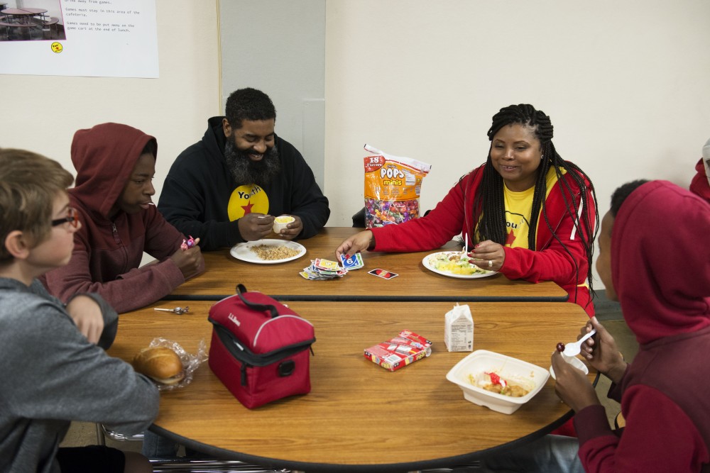 Community Outreach team members Byron Hawkins and  Lawanna Pitts play Uno with students on Friday, Dec. 7 at Patrick Henry High School. YCB Mentors offer guidance to students in areas where structured academics and athletics fall short. 