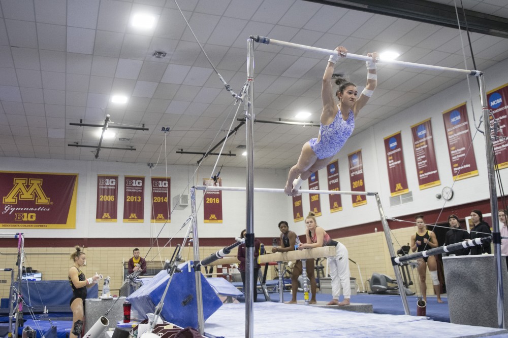 Sophomore Ona Loper practices on the beam on Tuesday, Jan. 29, 2019 at Peik Gymnasium on East Bank. 