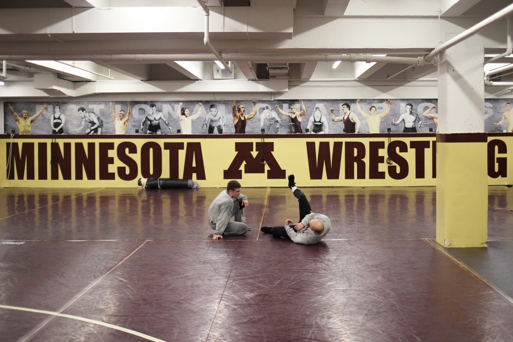 Luke Becker and Steve Bleise practice in the current wrestling space in Bierman Athletic complex. The University wrestling team received donations to move from their current practice facility to previous basketball practice facilities.