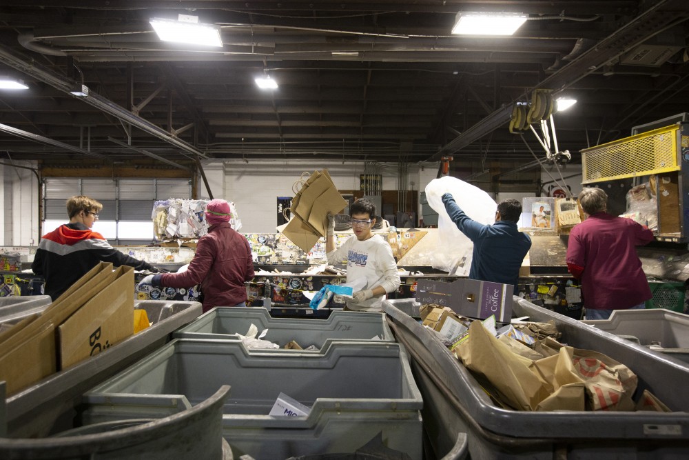 Employees sort waste into different recycling categories at the Como Recycling Facility on Friday, Jan. 18 in Minneapolis. 