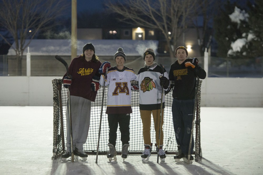 Austin Rush, Billy Landshof, Josh Czopek and Dylan Christy pose for a portrait at the Van Cleve Park ice rinks on Wednesday, Feb. 13. The rinks are currently used recreationally by players who are preparing for the upcoming inter-fraternity Lakes and Legends hockey tournament at Ridder Arena. 