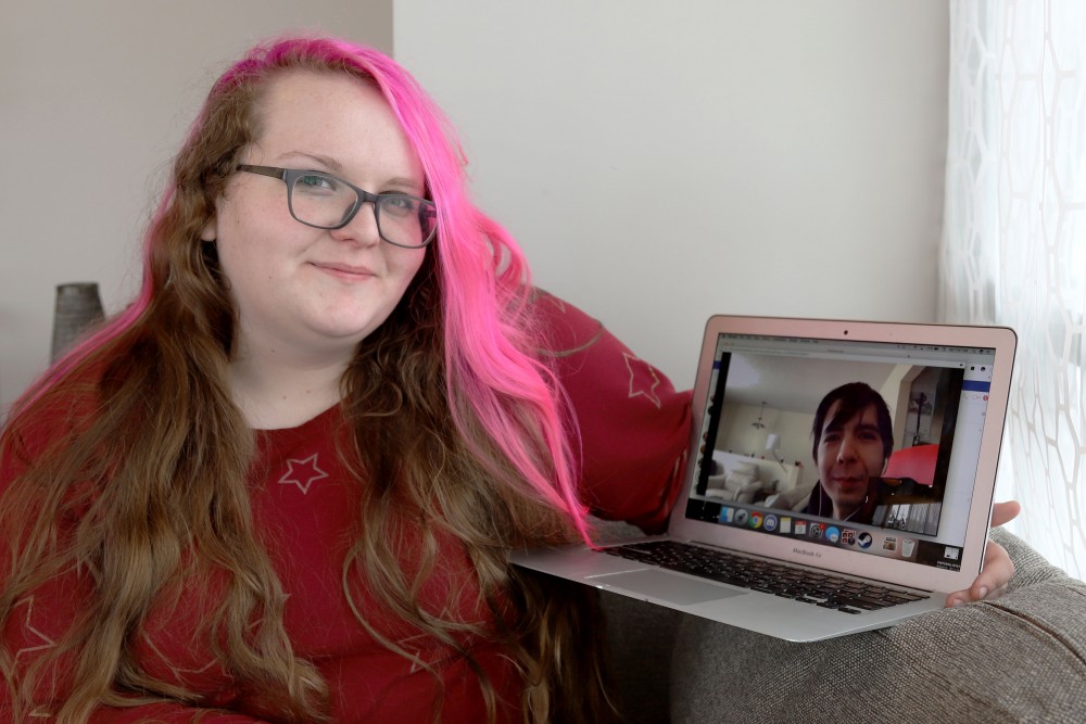 Anna Sherlock, left, and Ron Biggs, right, pose for a portrait during their Google Hangouts date on Saturday, Feb. 9 in Minneapolis. Sherlock and Biggs have only met in person once, but consider themselves in a relationship, and have plans to visit each other in the future.