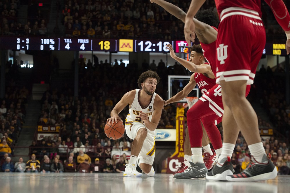 Freshman Gabe Kalscheur dribbles past Indiana University players on Saturday, Feb. 16 at Williams Arena. The Gophers won 84-63.