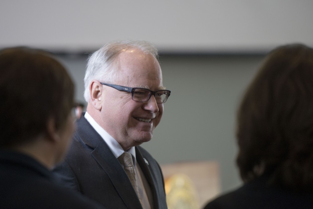 Gov. Tim Walz greets staff before he announced the state budget proposal at the Minnesota Department of Revenue building on Tuesday, Feb. 19.