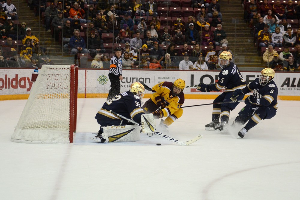 Junior Rem Pitlick tries to grab the puck near the net on Saturday, Feb. 23 at Mariucci Arena. The Gophers beat Notre Dame 2-1. 