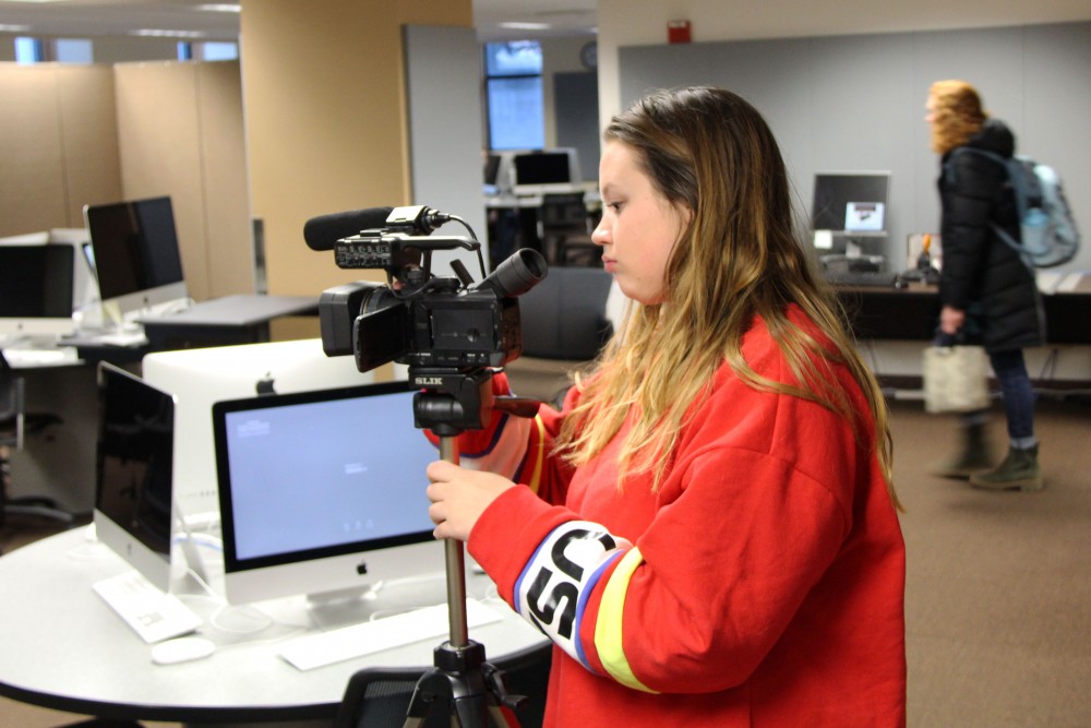 Kayla Finnerty sets up her camera on Wednesday, Feb. 19 in Murphy Hall. Finnerty is required to shoot video on campus for coursework in her digital content development and production for brand communications class.