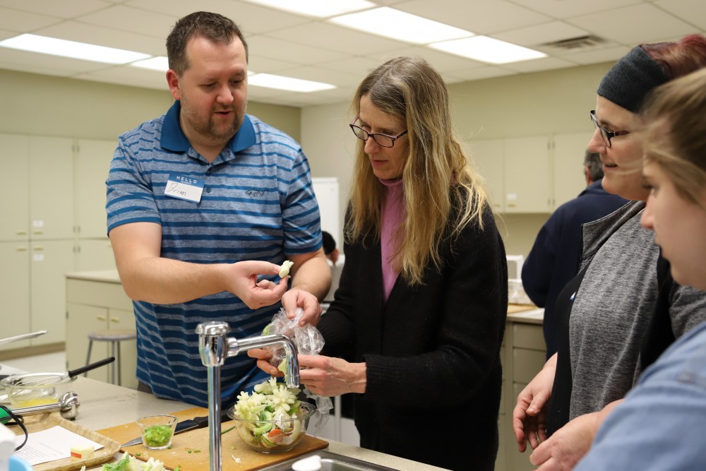 Robin Schow helps Brian Barnett to prepare soup at an employee wellness program on Monday, Feb. 25 at McNeal Hall in St. Paul. 