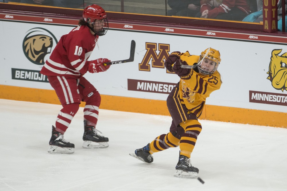 Forward Nicole Schammel passes the puck up the ice at Ridder Arena on Sunday, March 10. 