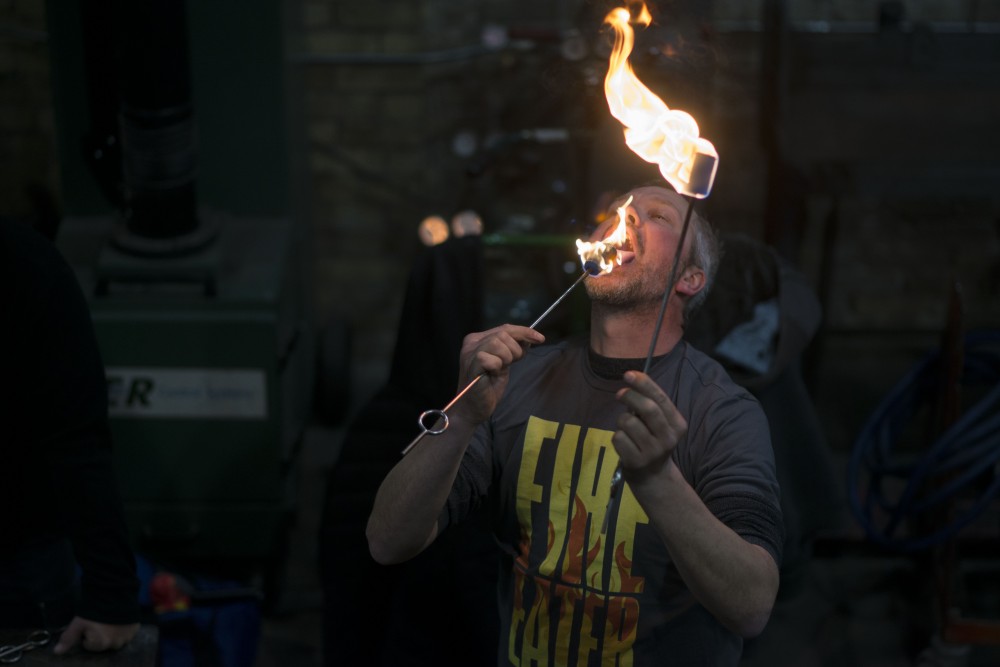 Troy Reem, a guest teacher at the Minneapolis Fire Collective, demonstrates the fire trick dragons breath during a fire breathing lesson on Friday, March 8.