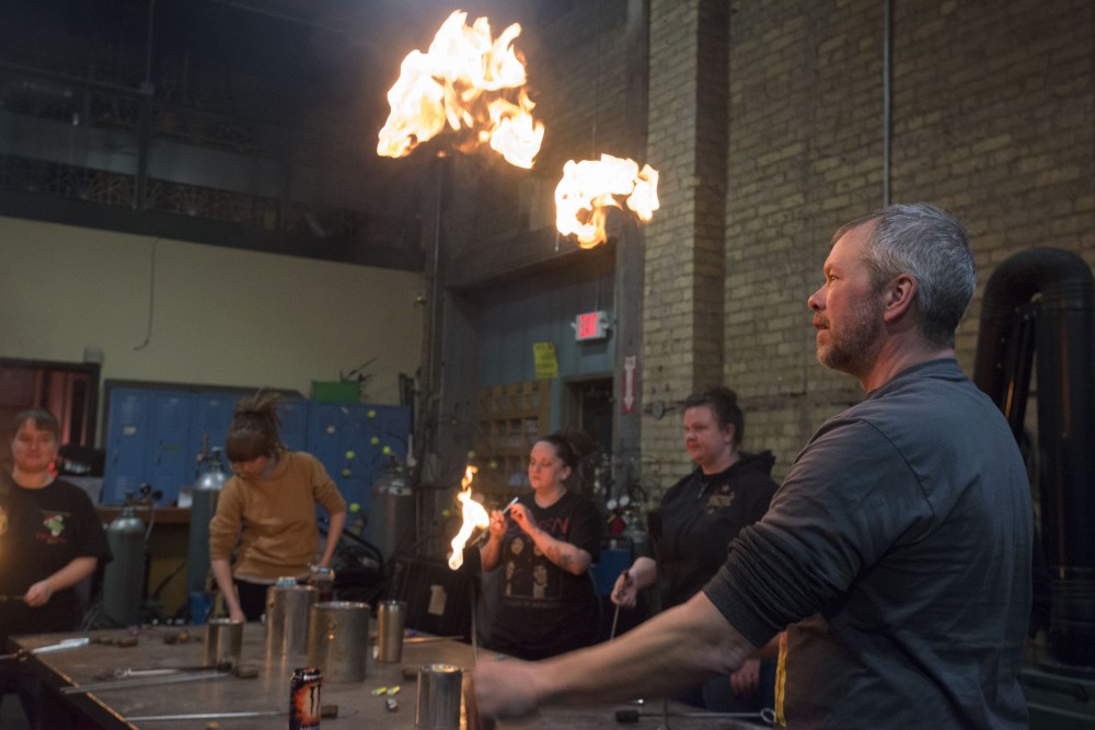Troy Reem, a guest teacher at the Minneapolis Fire Collective, demonstrates tricks during a class on Friday, March 8.
