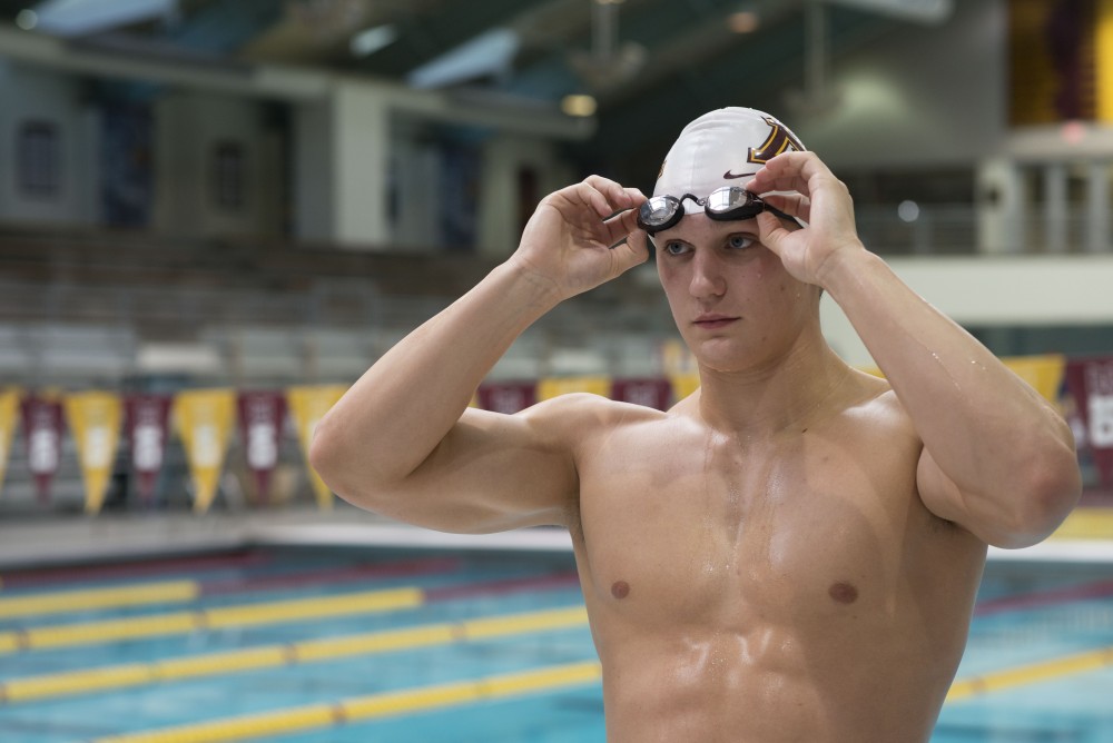 Max McHugh poses for a portrait in the Jean K.  Freeman Aquatic Center on Monday, March 11. McHugh was named as the Big Ten Freshman of the Year. 
