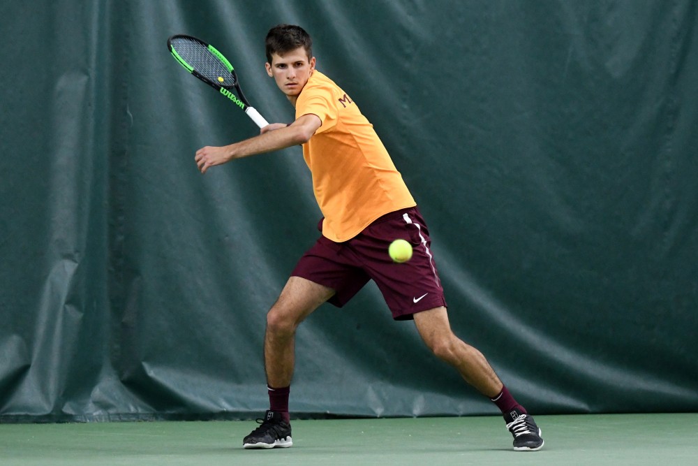 Senior Marino Alpeza competes in his singles match on Friday, March 22 at the Baseline Tennis Center. 