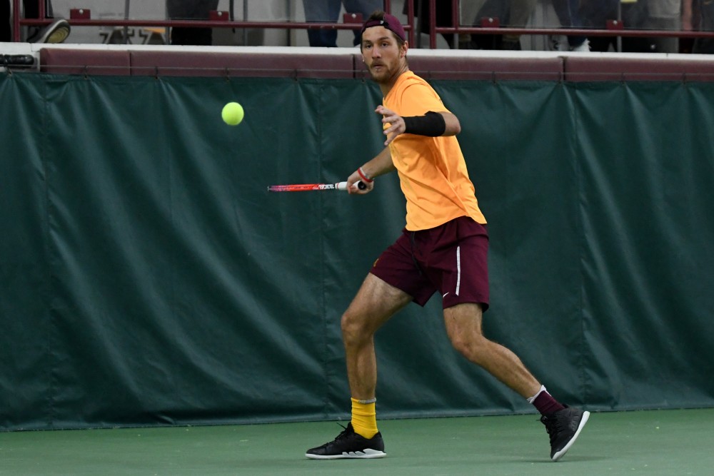 Junior Stephen Milicevic looks to return the ball on Friday, March 22 at the Baseline Tennis Center. 