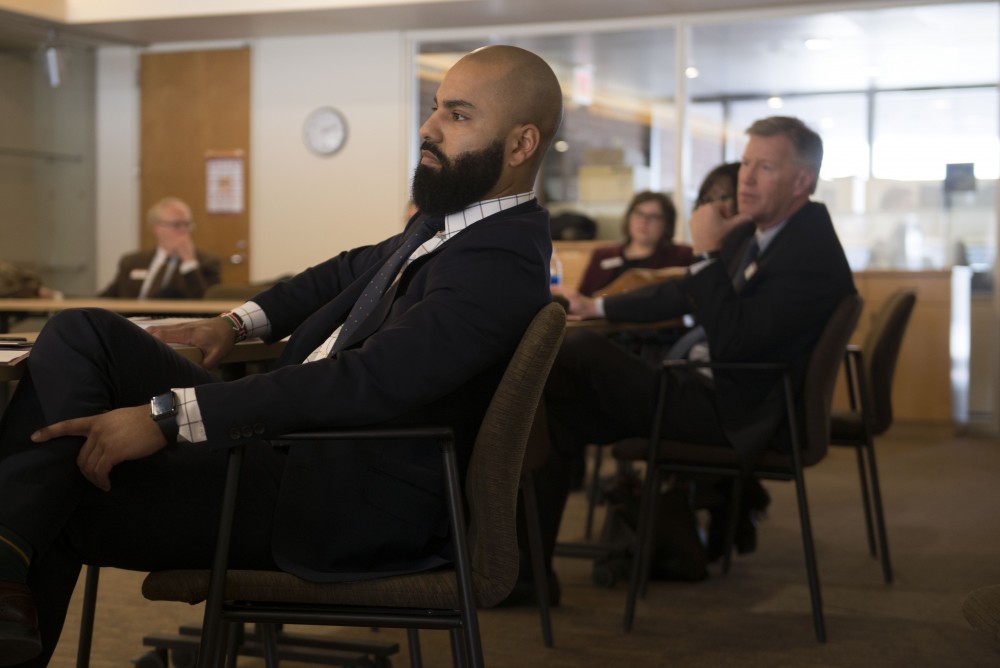 Regent Abdul Omari listens to student representatives from the law school in Mondale Hall during the Board of Regents West Bank professional programs visit on Thursday, March 7. 