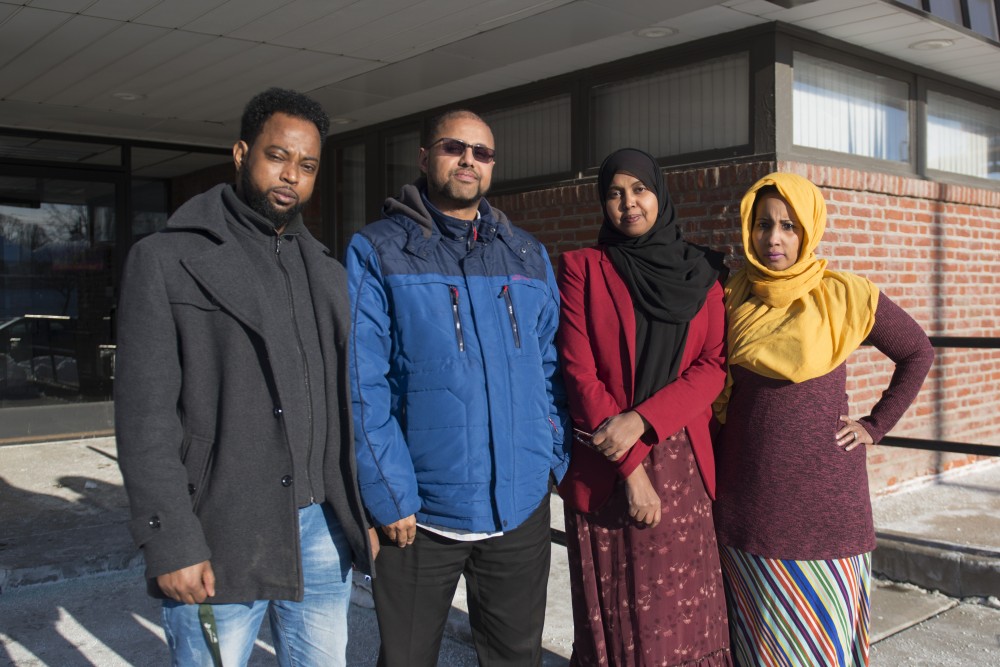 Freelance interpreters Ahmed Hassan, AK Hassan, Suad Muse and Huda Mire pose for a portrait outside of the Hiawatha Business Center in Minneapolis on Wednesday, March 6.