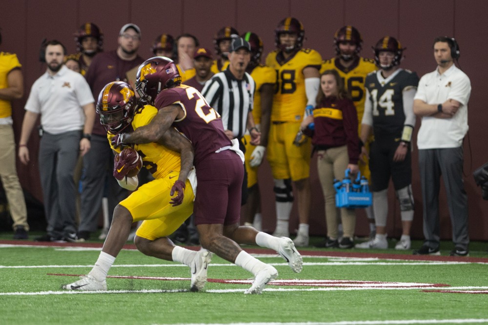 Senior Tyler Johnson attempts to avoid a tackle on Saturday, April 13 at the football facility in Athletes Village. The Gopher football team participated in their annual spring football game. 

