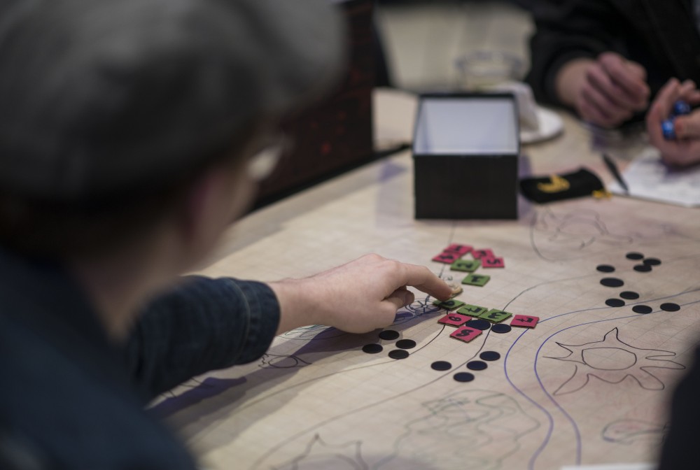 Evan Berg makes his move during a Game of Thrones and Dungeons and Dragons inspired game on Saturday, April 13 in Coffman Memorial Union. The event, A Song of Dice and Fire, was put on in celebration of the final season premiere of Game of Thrones on Sunday, April 14. 