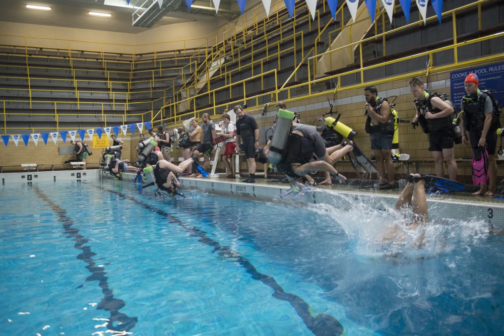 Students somersault into the water on Wednesday, April 17 during scuba diving class in Cooke Hall.