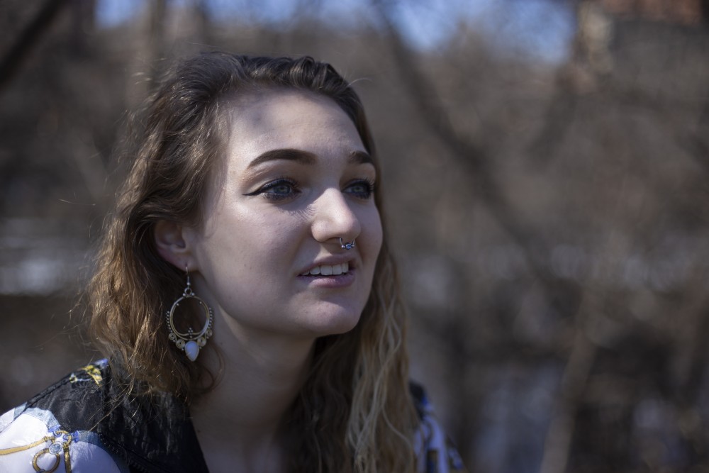 Sophomore Sophie ORourke poses for a portrait near the Mississippi River on Friday, April 19. ORourke, who has fibromyalgia and identifies as a person with an invisible disability, used the space to decompress after her summer job at Comstock Hall.