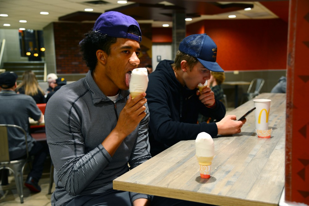 12:08 a.m.
Jared Crawford-Akeredolu and Mason Gallagher, students at Anoka Ramsey Community College, eat ice cream cones at the Dinkytown McDonalds. 