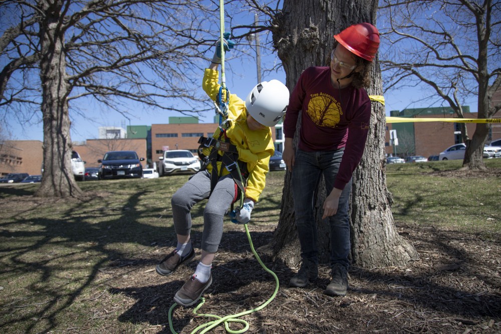 1:39 p.m.
August Mossman tries tree climbing for the first time at Foresters Day, hosted by the Universitys Forestry Club, in St. Paul.