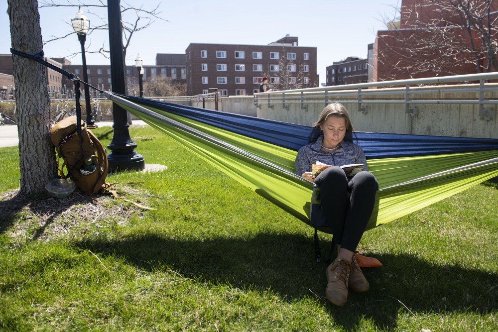 1:55 p.m.
Undecided freshman Keelin Posson reads on a hammock outside of Coffman Union. 
