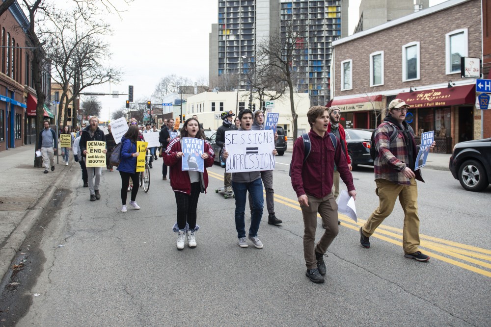 Demonstrators walk down S Washington Ave to protest the presence of Jeff Sessions on campus and his speaking at the Carlson School of Management on Monday, April 15. 