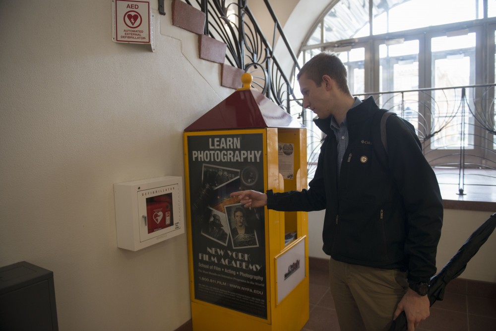 Jacob Erdman points to the defibrillator he used in Nicholson Hall while saving Mike Vaughans life this March.