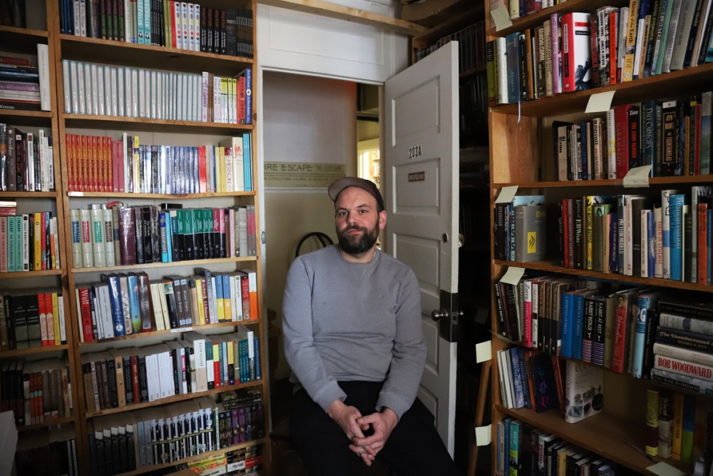 Matt Hawker co-owner and manger of The Book House poses for a photo on Thursday May 2. Hawker wants to encourage diversity in books distributed in Dinkytown. 