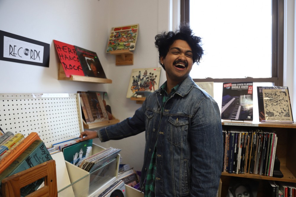 Ajay Raghuraman laughs with his fellow band members as he browses through records at The Book House in Dinkytown on Thursday, May 2. 