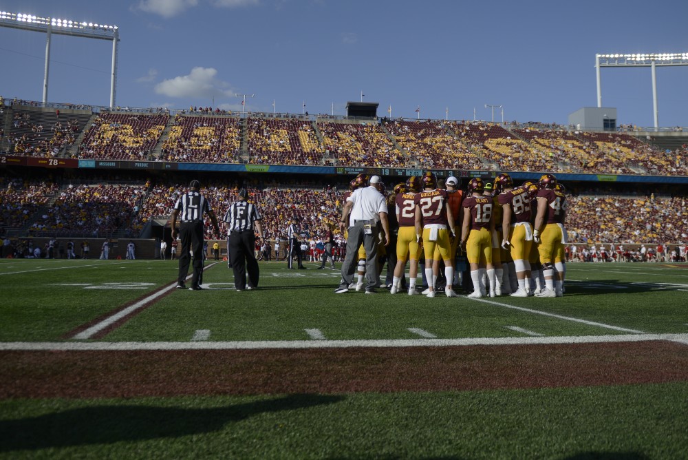 The Gopher football team huddles during a time out on Saturday, Sept. 15 at TCF Bank Stadium in Minneapolis.