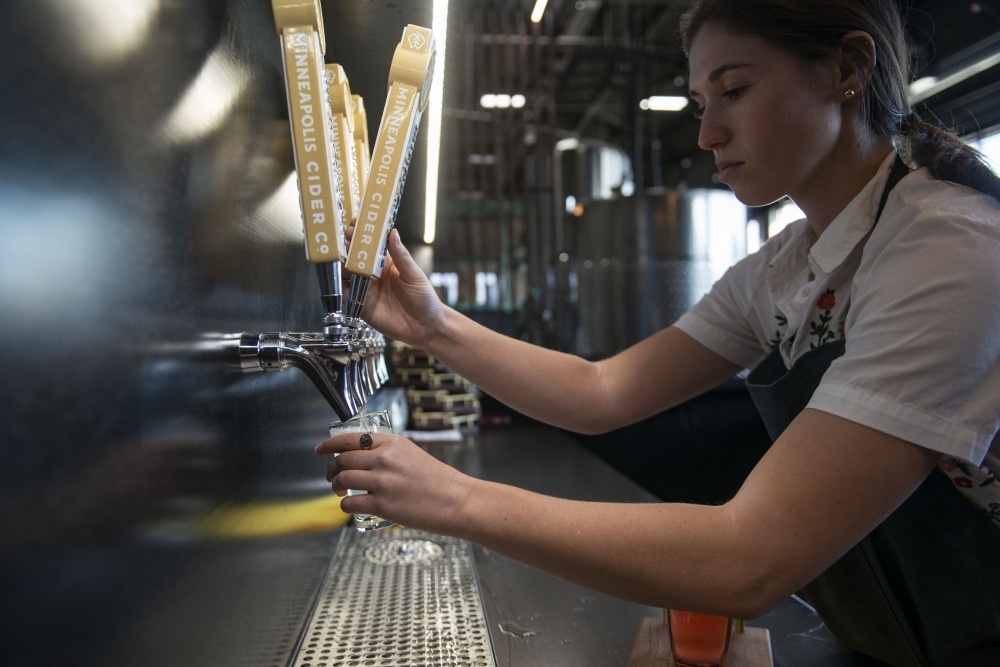 Roxy Krietzman pours a flight of ciders at Minneapolis Cider Co. on Thursday, June 6.