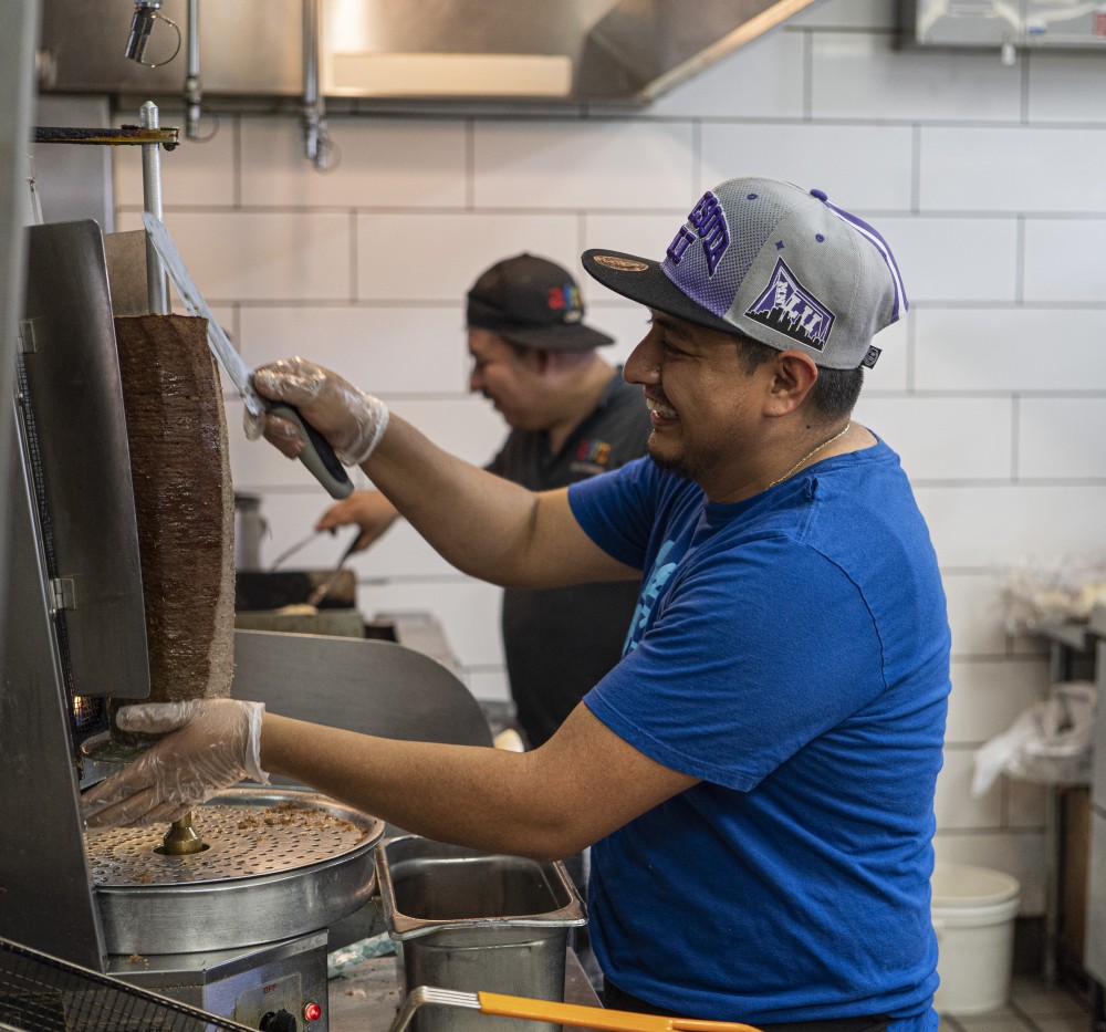 Cook Danny Herrera cuts lamb shawarma on Friday, June 28 at Afro Deli in Stadium Village, Minneapolis. 