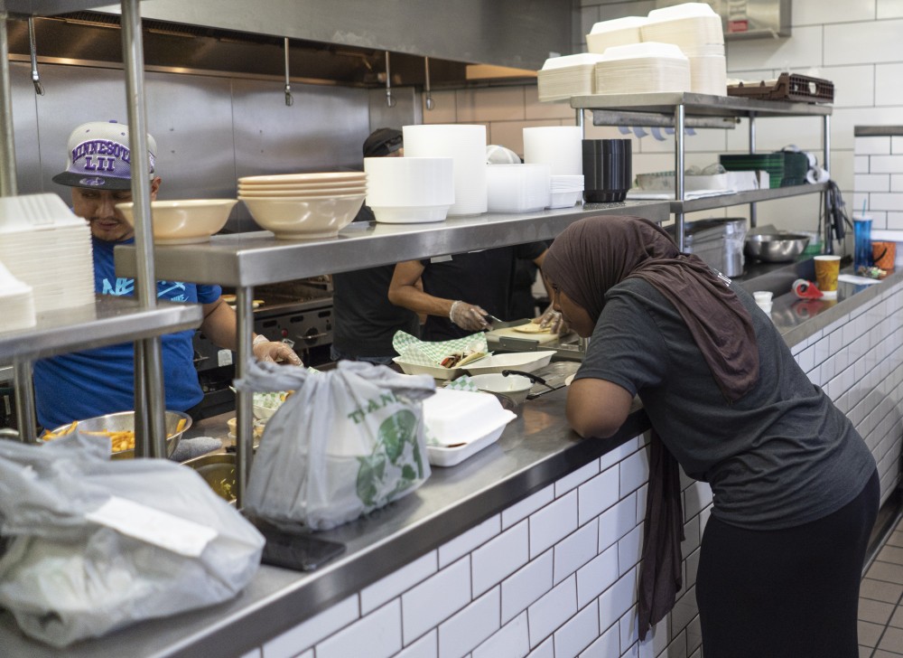Safia Suleiman waits for an order to come out on Friday, June 28 at Afro Deli in Stadium Village, Minneapolis. 
