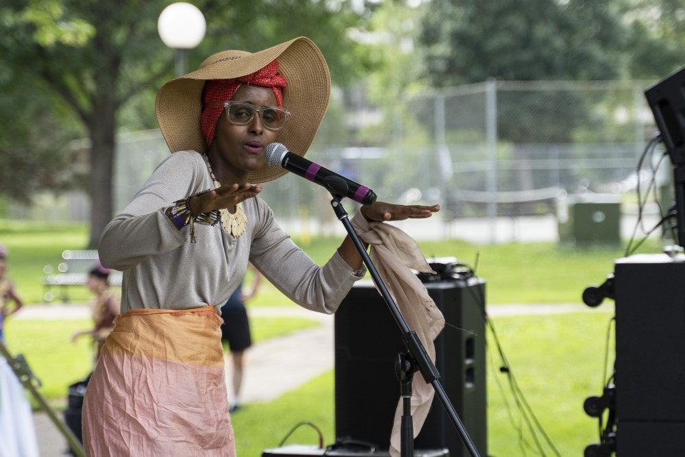 Ifrah Mansour voices one of her self-written poems for the crowd at the World Refugee Day festival in Loring Park on Sunday, July 14.