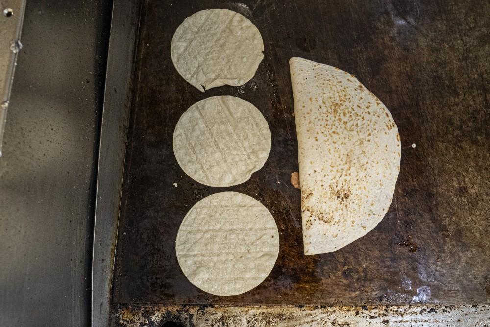 Tortillas cook on the grill at El Taco Riendo on Central Avenue in Minneapolis on Friday, July 19.