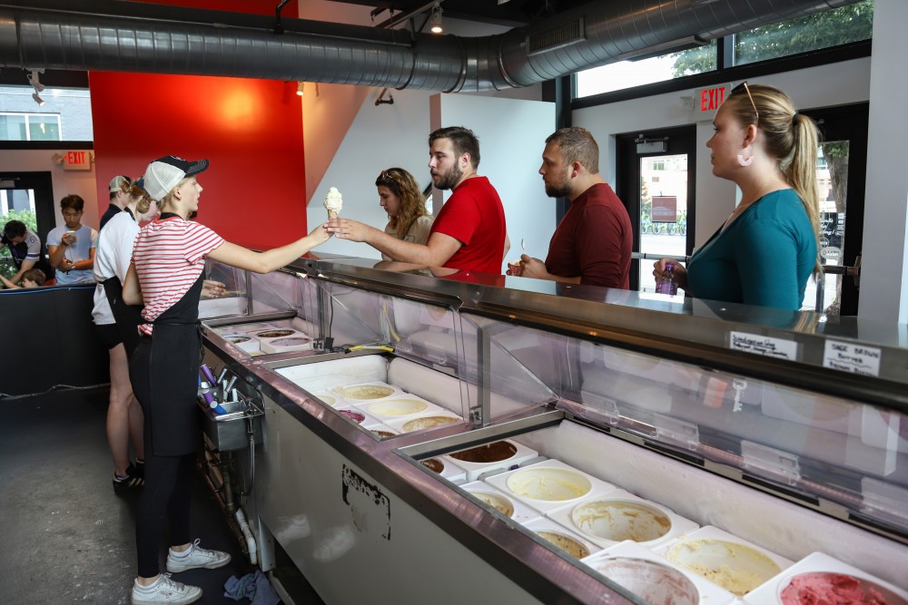 Customers order ice cream after waiting a long line at Izzys Ice Cream in Minneapolis on Saturday, July 20.