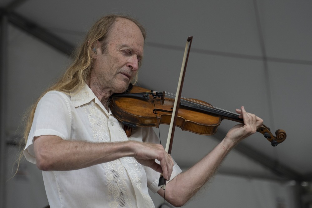 Donald Pearson plays his violin during a performance at Musica Juntos at Peavy Plaza in Minneapolis on Friday, July 26. 
